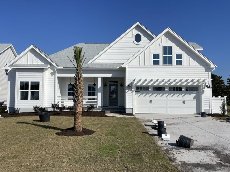 Front exterior of a new home in The Sanctuary at Sunset Beach, Sunset Beach, NC, highlighting curb appeal (Image 1).