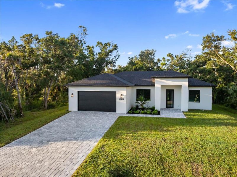 Front exterior of a new home in , Port Charlotte, FL, highlighting curb appeal (Image 26).