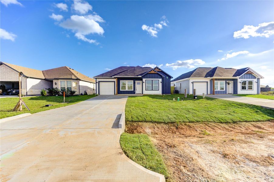 Front exterior of a new home in , Cleveland, TX, highlighting curb appeal (Image 22).