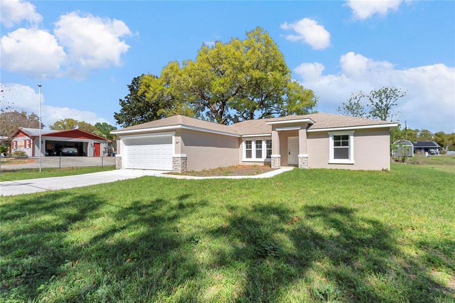 Front exterior of a new home in , Summerfield, FL, highlighting curb appeal (Image 26).