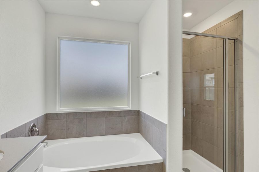A well-appointed bathroom with a spacious soaking tub and a sleek, modern walk-in shower.
