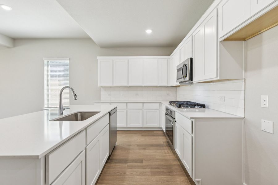 Kitchen in the Stanley II home plan by Trophy Signature Homes – REPRESENTATIVE PHOTO