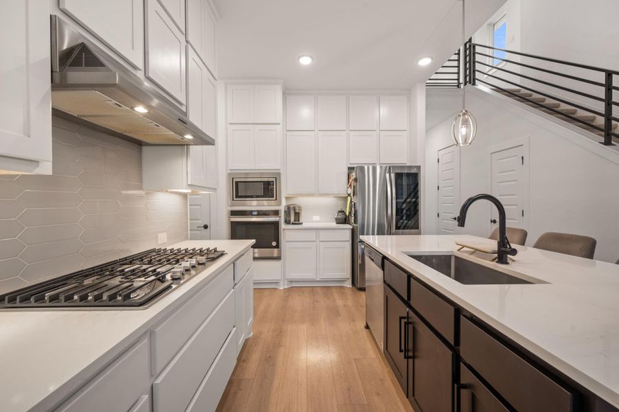 Lots of quartz counter space and built in gas top and built in oven and microwave for cooking ease