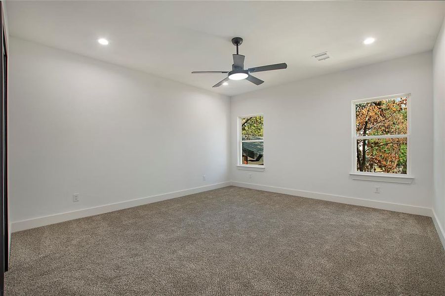 Spare room with carpet and ceiling fan