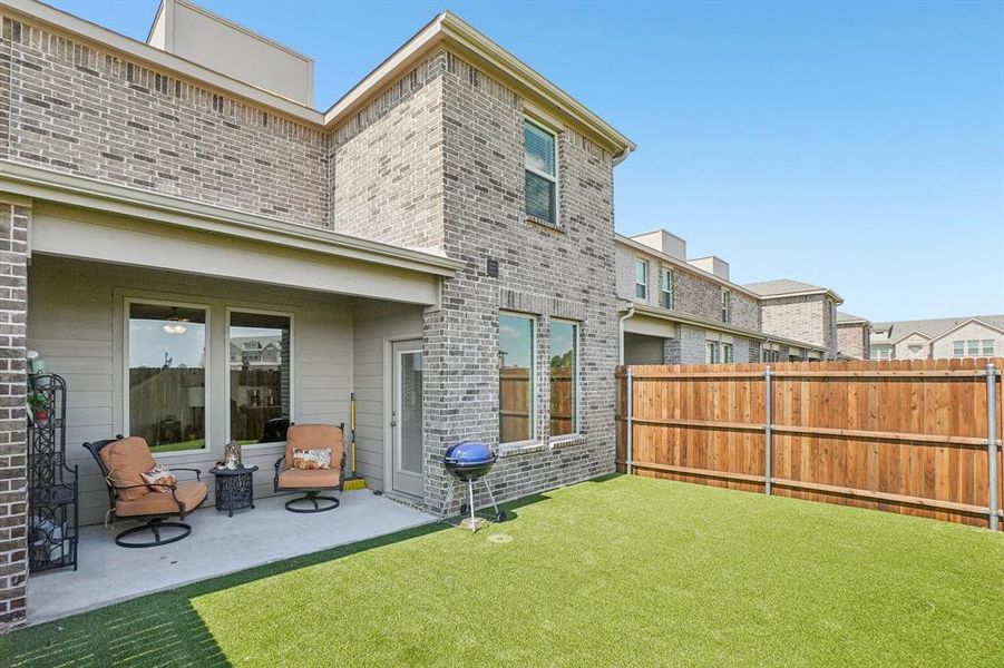 Rear view of house featuring a fenced backyard, brick siding, and a patio Rear view of house featuring a fenced backyard, brick siding, and a patio