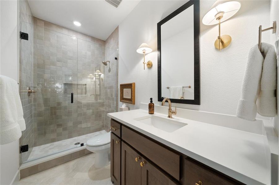 Bathroom with vanity, toilet, and walk in shower