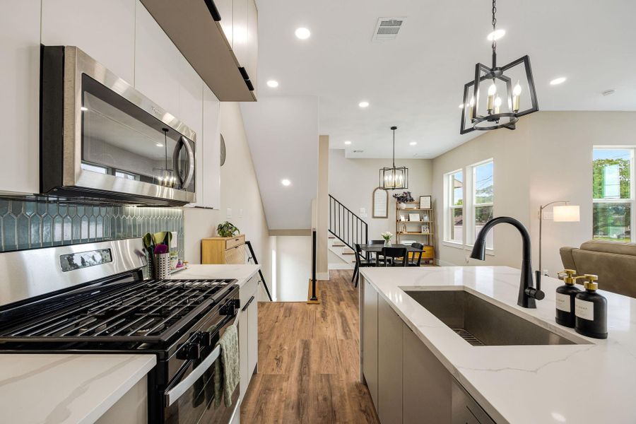 Designer kitchen featuring stainless steel appliances, abundant cabinetry, and generous prep space. Designer kitchen featuring stainless steel appliances, abundant cabinetry, and generous prep space.