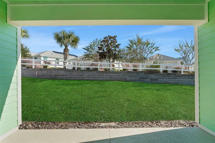 Exterior details and patio area of a home in Green Key Village, Lady Lake (Image 4).