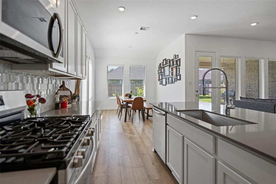 Love the gas stove and quartz counter tops.