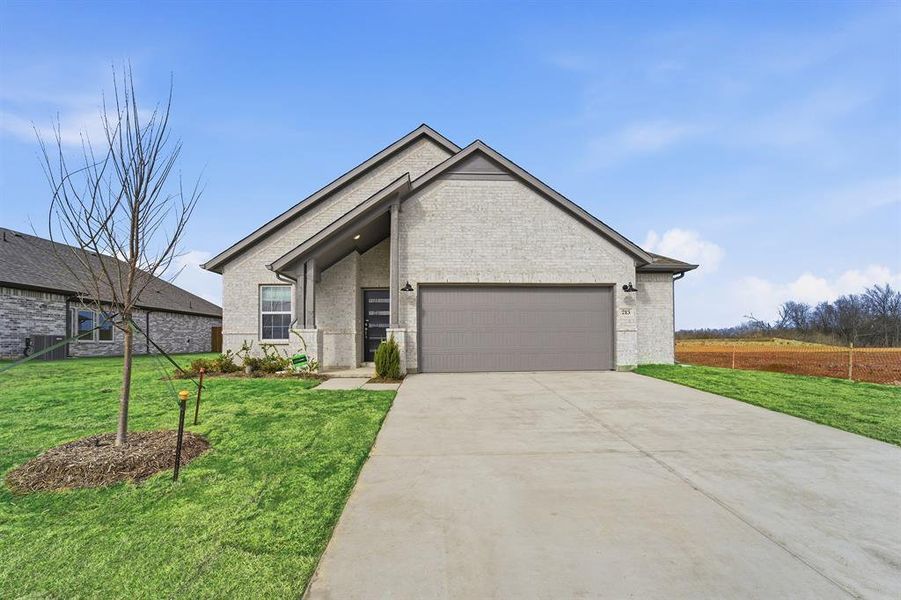 Front exterior of a new home in Saddlebrook Estates, Waxahachie, TX, highlighting curb appeal (Image 18).