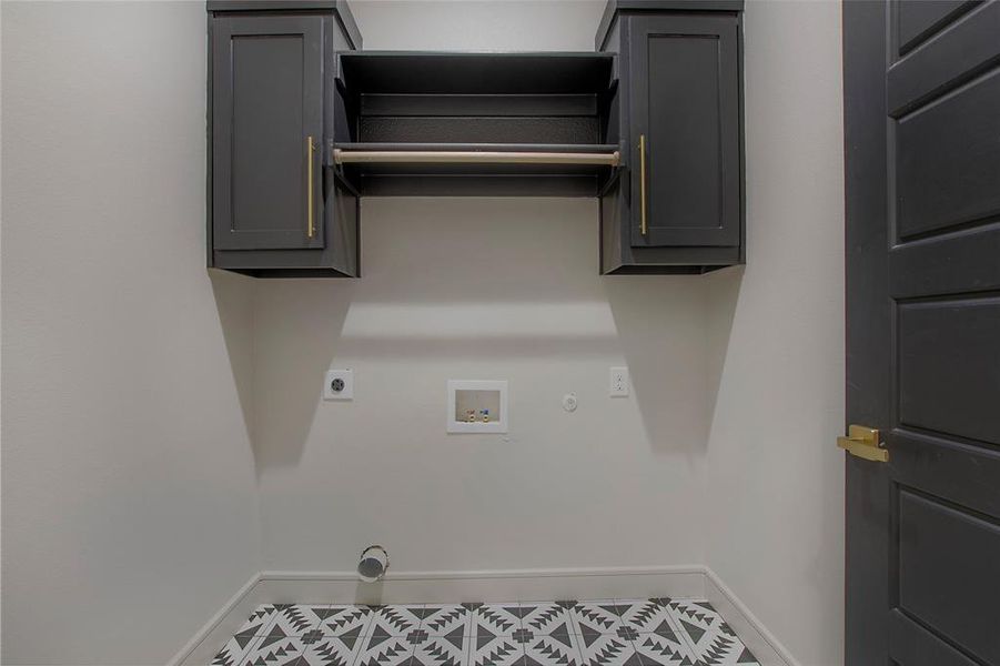 Laundry room featuring gas dryer hookup, cabinets, tile patterned floors, hookup for a washing machine, and hookup for an electric dryer