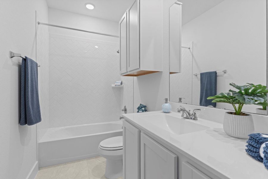 Fresh and functional full guest bathroom featuring a tub/shower combo, white cabinetry, wide vanity space, and modern fixtures. **Image Representative of Plan Only and May Vary as Built**.