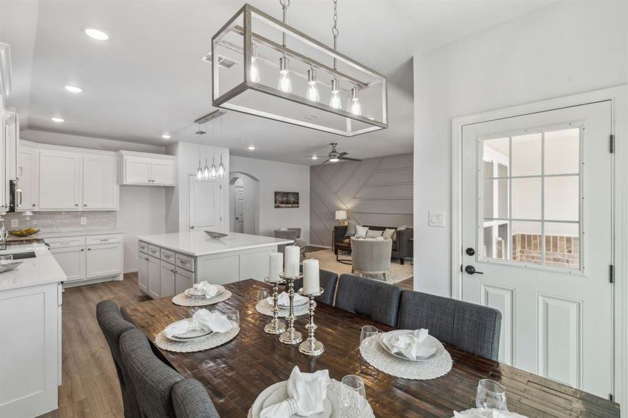 Dining space with sink, ceiling fan, and hardwood / wood-style floors