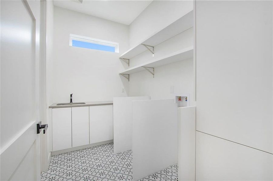 Laundry room featuring cabinets, hookup for a washing machine, and sink