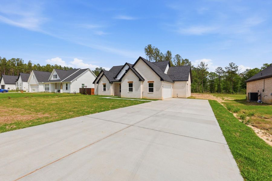 Front exterior of a new home in , Dayton, TX, highlighting curb appeal (Image 19).