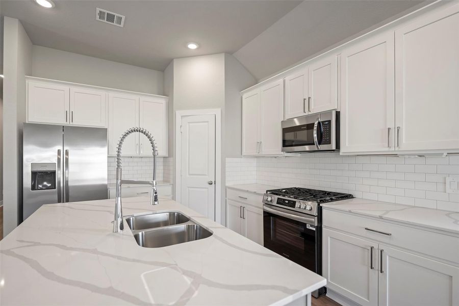 Oversized island provides extraseating and prep space — ideal forfamily meals or casual entertaining. Oversized island provides extraseating and prep space — ideal forfamily meals or casual entertaining.