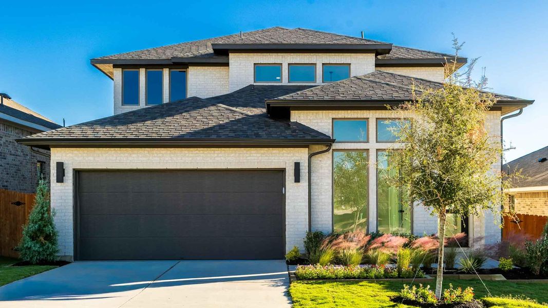 Front exterior of a new home in Lariat 50', Liberty Hill, TX, highlighting curb appeal (Image 2). Front exterior of a new home in Lariat 50', Liberty Hill, TX, highlighting curb appeal (Image 2).