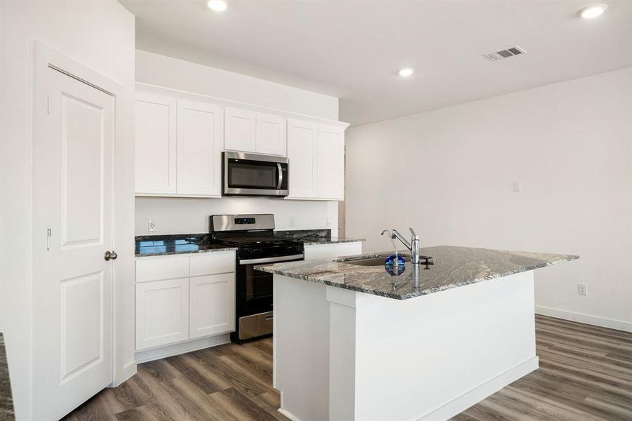 This kitchen is by far any chef’s dream! This spacious kitchen features high ceilings, bright white cabinets, granite countertops, SS appliances, recessed lighting, granite kitchen island with double sink and space for breakfast bar, and a walk-in pantry all overlooking your huge family room.