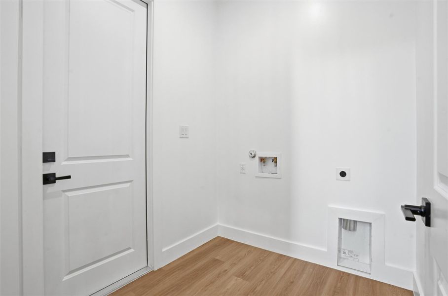 Laundry room with light wood finished floors, washer hookup, and hookup for an electric dryer
