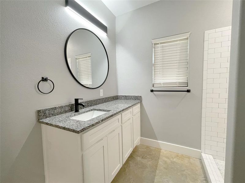 Bathroom with tile patterned flooring and vanity