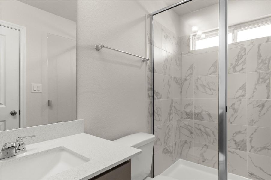 Full bath with vanity, a textured wall, and a shower stall Full bath with vanity, a textured wall, and a shower stall