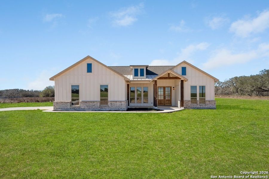 Front exterior of a new home in , Poteet, TX, highlighting curb appeal (Image 26).