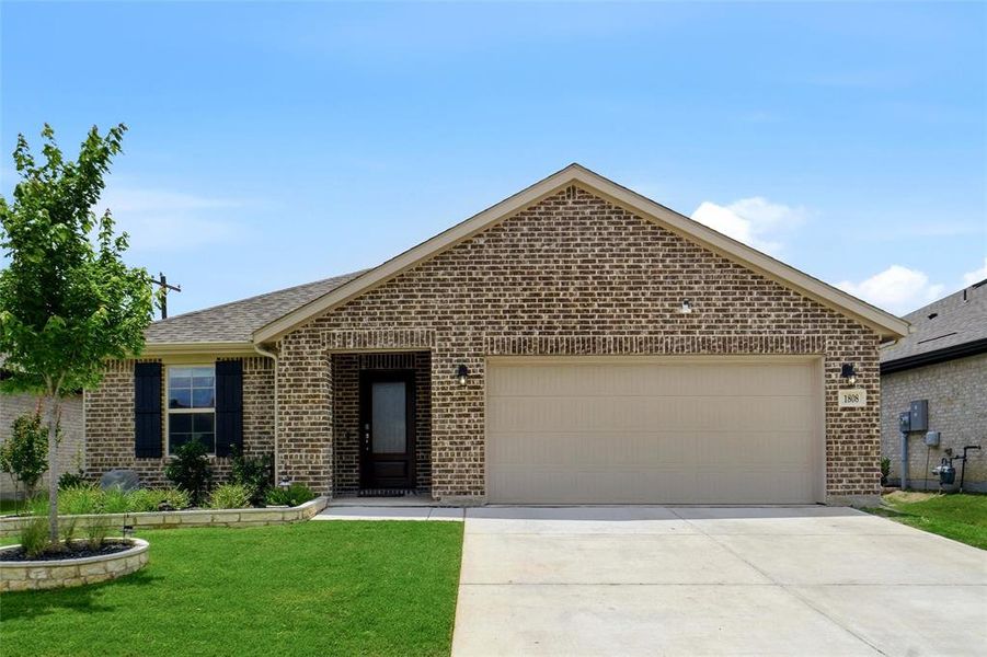 Front exterior of a new home in Stark Farms, Denton, TX, highlighting curb appeal (Image 1). Front exterior of a new home in Stark Farms, Denton, TX, highlighting curb appeal (Image 1).