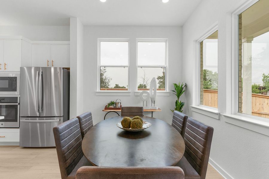 Dining space with light wood-type flooring and recessed lighting Dining space with light wood-type flooring and recessed lighting