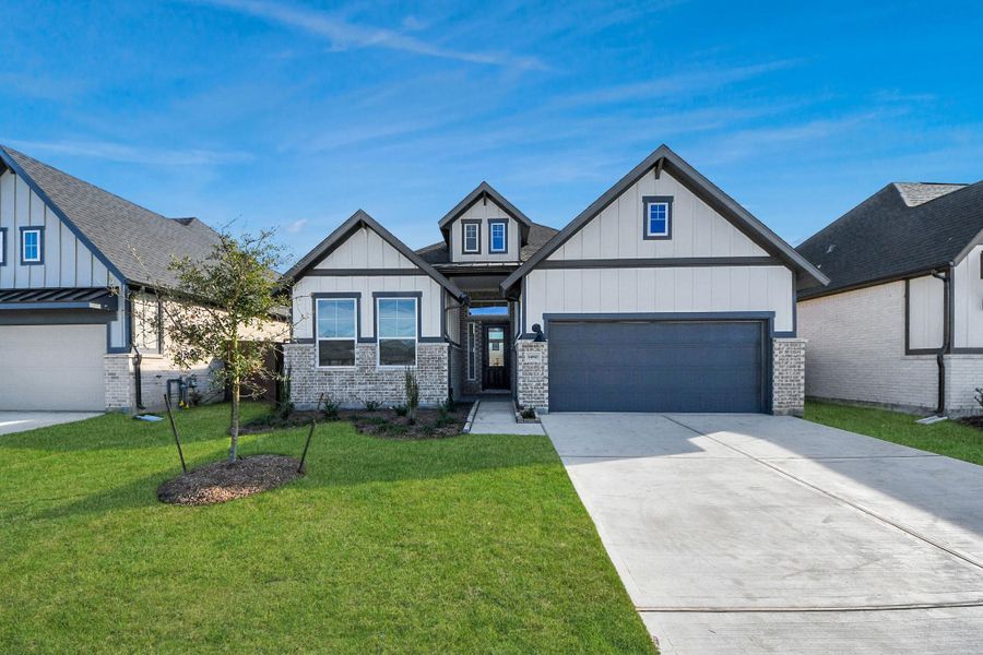 Front exterior of a new home in Meridiana 50's, Manvel, TX, highlighting curb appeal (Image 2).