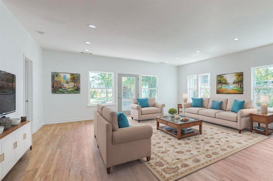 Virtually Staged - Living room featuring light wood-type flooring and plenty of natural light