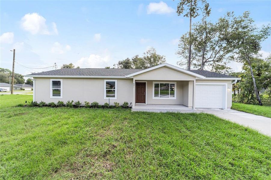 Front exterior of a new home in , Silver Springs, FL, highlighting curb appeal (Image 2).