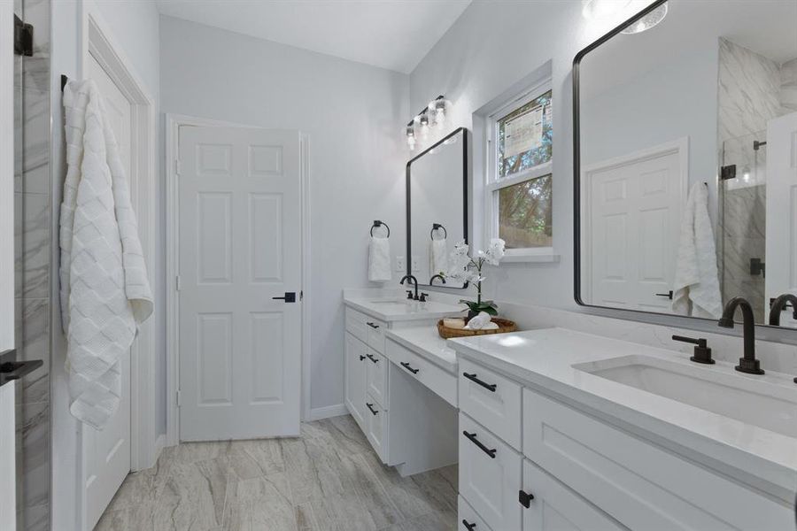 Bathroom with double vanity and a marble finish shower Bathroom with double vanity and a marble finish shower