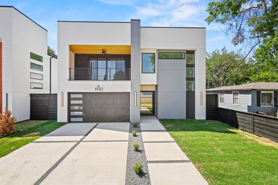 Contemporary home with a balcony and a front yard