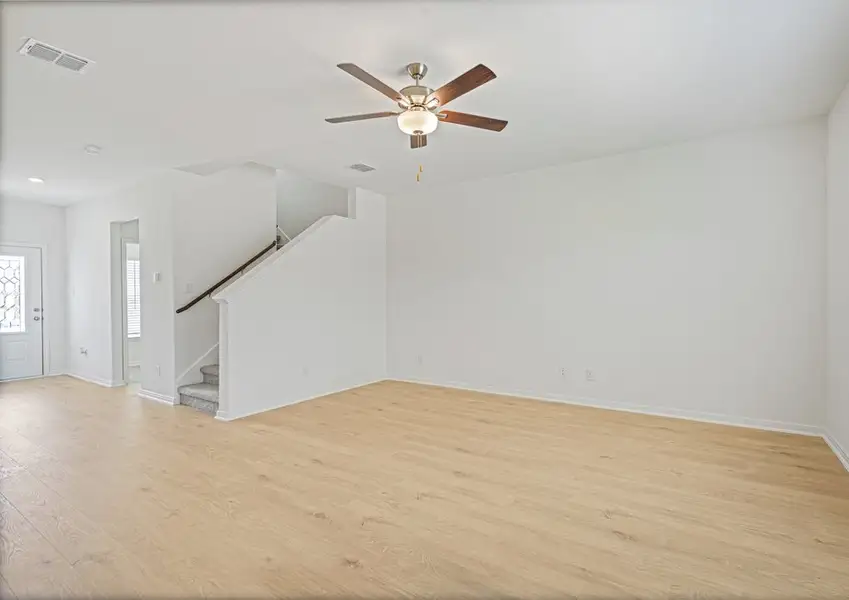 Spacious family room with a window overlooking the back yard