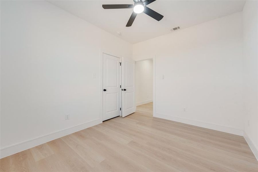 Empty room featuring ceiling fan and light hardwood / wood-style floors