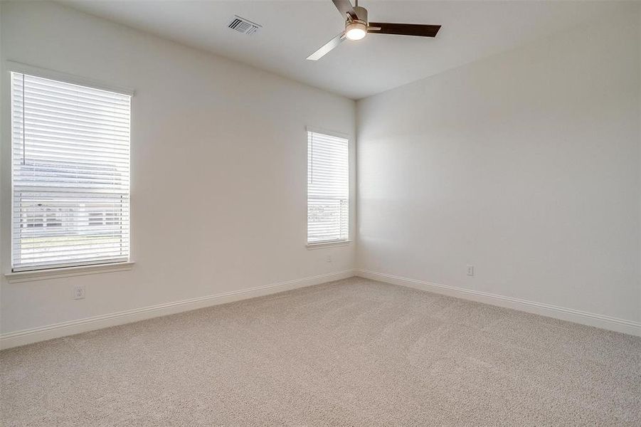 large 3rd bedroom with large walk in closet, ceiling fan