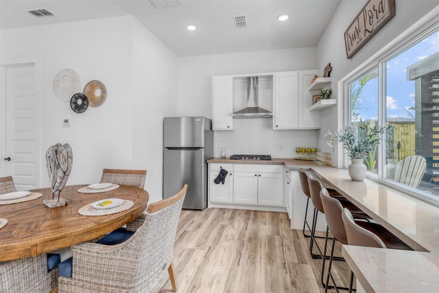 Casita features a full kitchen with gas stovetop, stainless steel hood, granite countertops, sink, custom white cabinetry, and large sliding windows that conveniently open up to the outdoor bar!Yes, this is the fourth kitchen in the home, if you are counting!