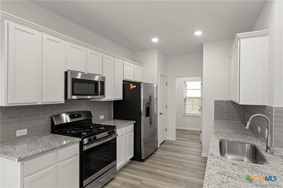 Furnished interior view inside a new home in Crosswinds, Kyle (Image 9).