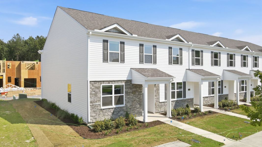 Front exterior of a new home in Clock Road Townhomes, New Bern, NC, highlighting curb appeal (Image 1). Front exterior of a new home in Clock Road Townhomes, New Bern, NC, highlighting curb appeal (Image 1).