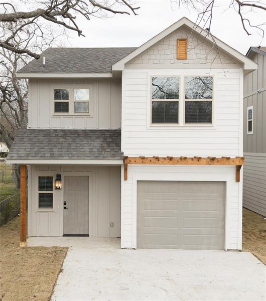 View of front facade featuring a garage