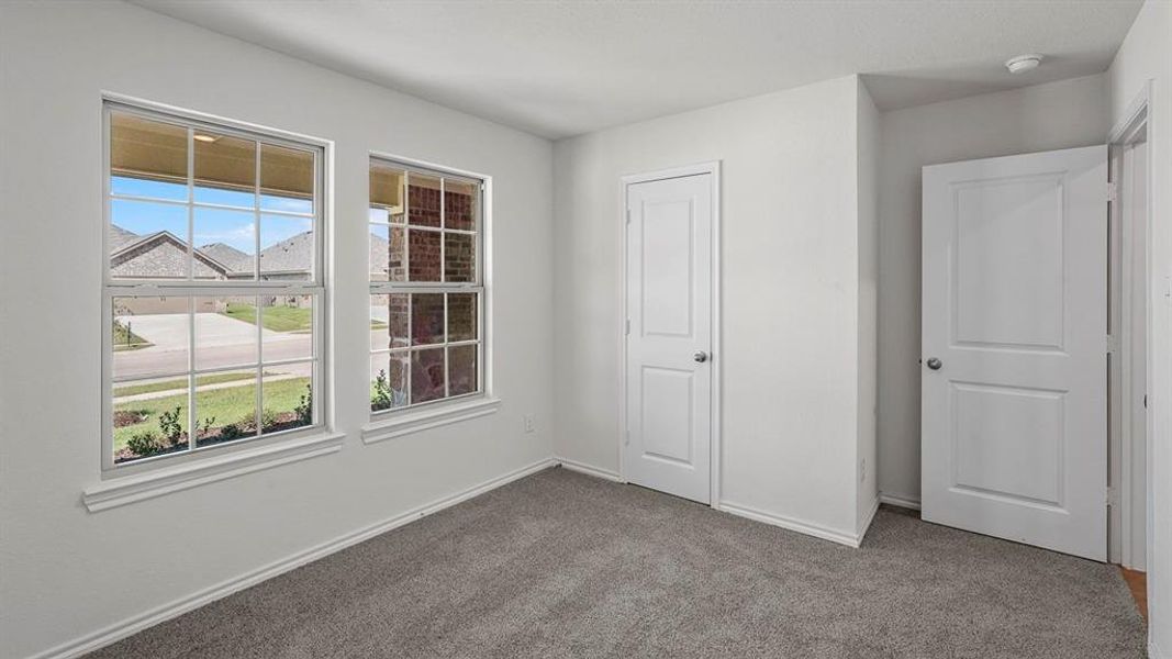 Room featuring neutral-toned carpet flooring and white painted walls