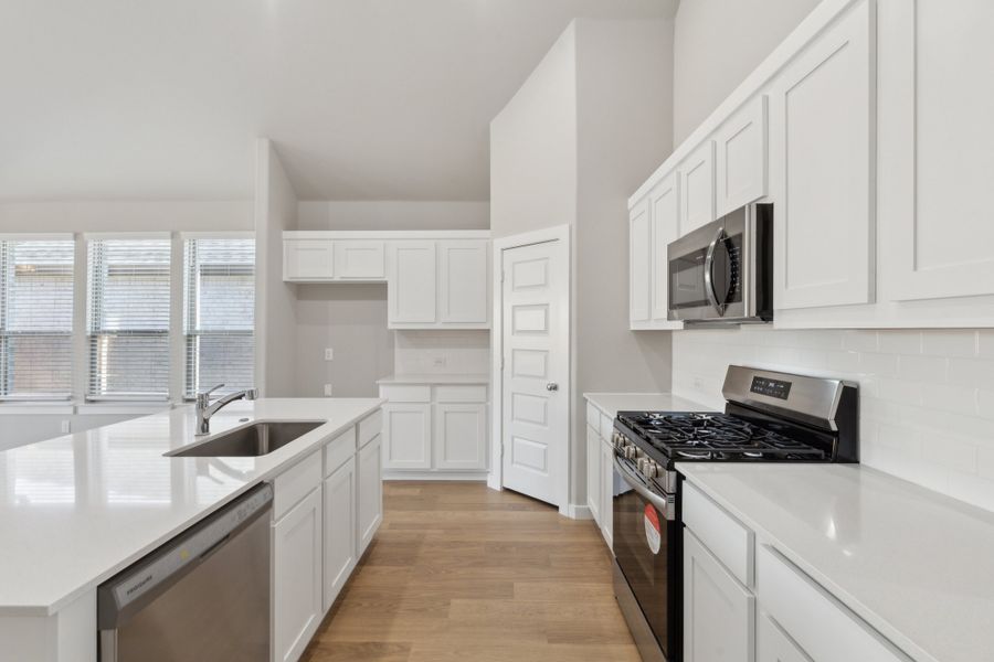 Kitchen in the Claret home plan by Trophy Signature Homes – REPRESENTATIVE PHOTO