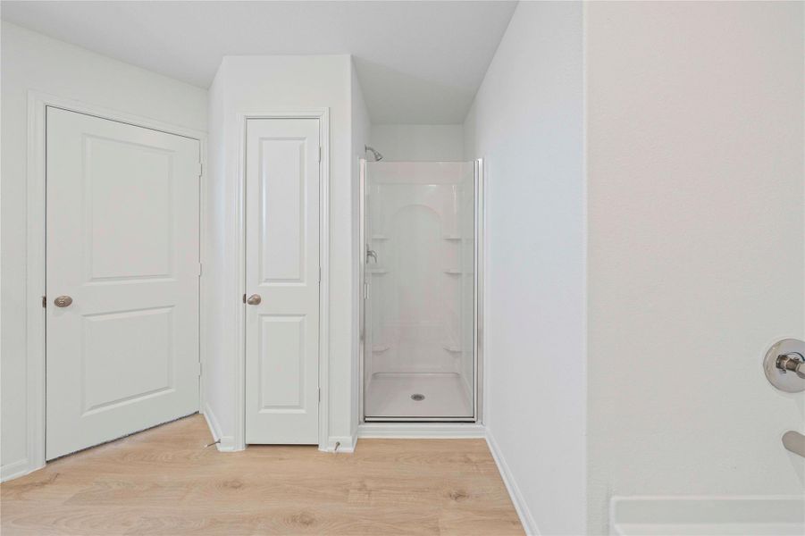 A pristine shower enclosure provides a clean and functional space in this bathroom. A pristine shower enclosure provides a clean and functional space in this bathroom.