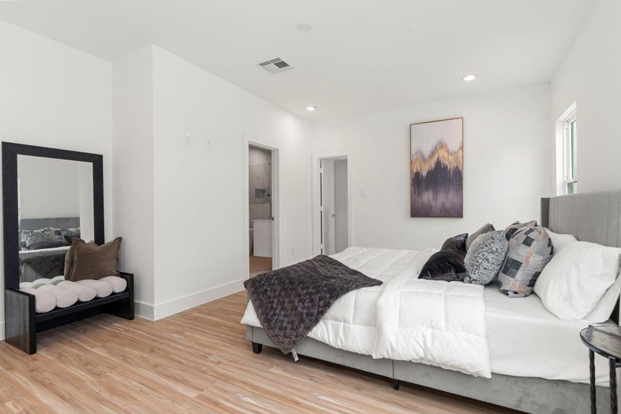 This light-filled retreat features sleek laminate flooring, recessed lighting, and a private en-suite bath—designed for comfort and style.
