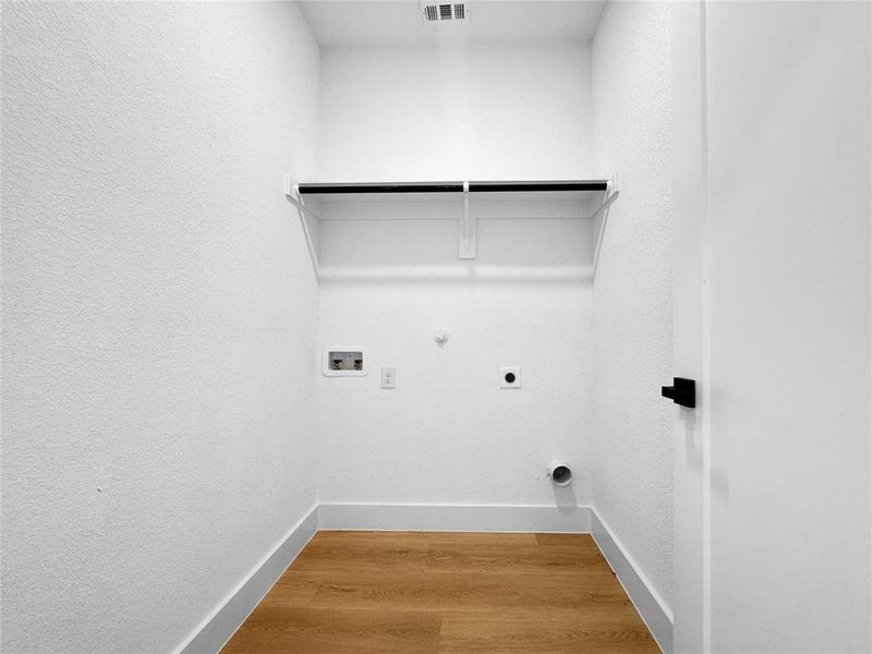 Laundry room with hookup for a gas dryer, light wood-type flooring, hookup for an electric dryer, and washer hookup