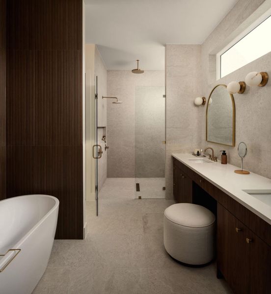 A well-lit, contemporary primary bathroom offers dual vanities, a spacious walk-in shower, and a freestanding tub. A well-lit, contemporary primary bathroom offers dual vanities, a spacious walk-in shower, and a freestanding tub.