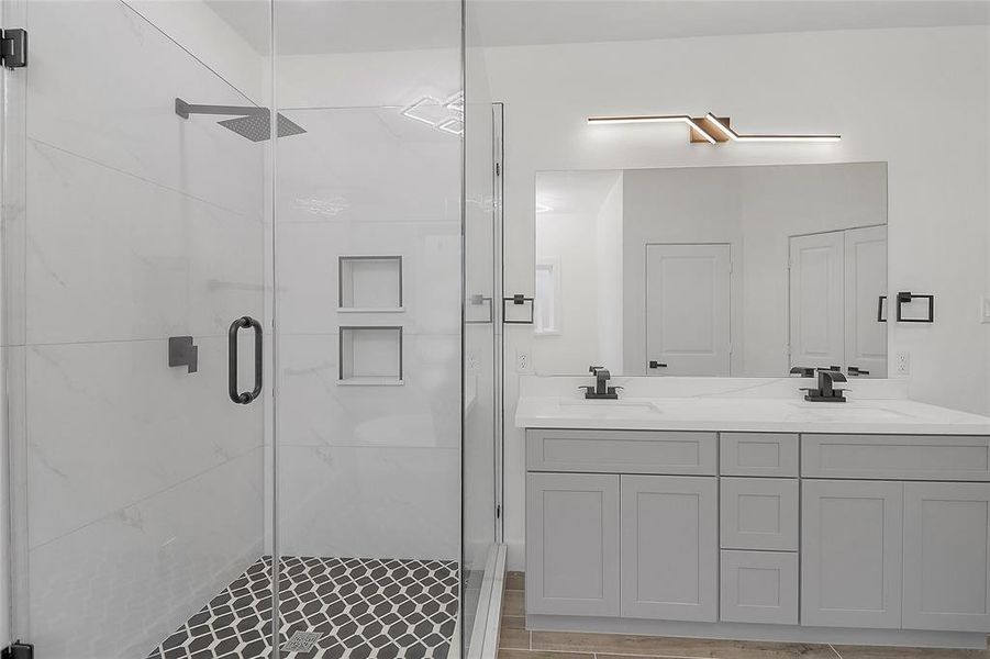 This stunning shower is a sanctuary of tranquility, featuring a sleek and modern design that exudes sophistication. Encased in floor-to-ceiling glass, the shower showcases exquisite tile work, creating a seamless blend of elegance and functionality.