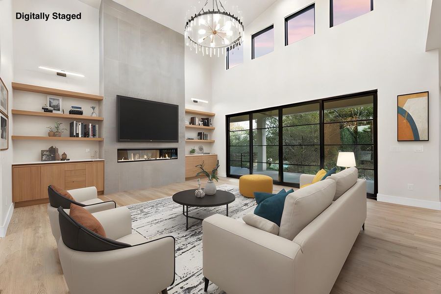 A grand living space with towering ceilings and panoramic outdoor views.
