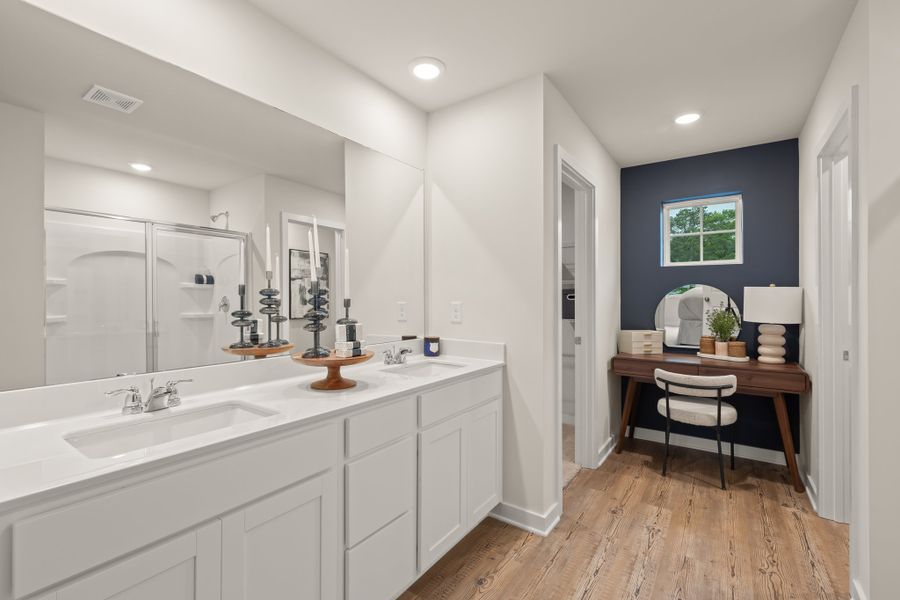 A bathroom with a tub sink and a mirror. A bathroom with a tub sink and a mirror.