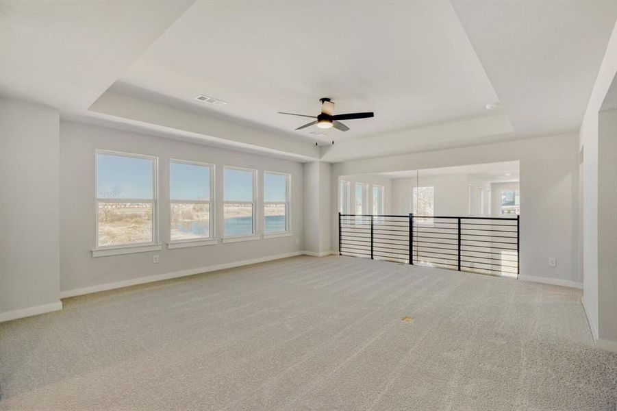 Expansive game room with modern railing overlooking the family room